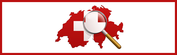 Magnifying glass resting on a map of Switzerland decorated with the Swiss flag